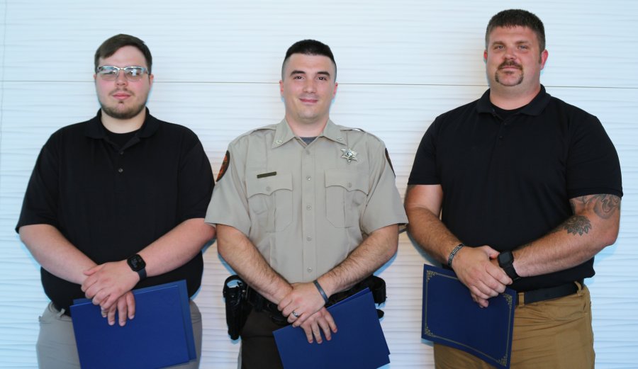 (From left) Guage Franks, recipient of the Academic (Honor Graduate) Award for having the highest grade point average; Alan Lewis, recipient of the “Top Gun” award for excellence in marksmanship; and Douglas Brown, student speaker for the ceremony, pose for a picture after the ceremony.